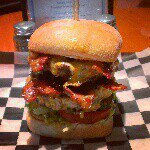 LBOE Burger Of The Day Ring it up, put 3 on the board!'. : 8 oz. seasoned beef party, topped with American.cheese, beer battered onion rings, hardwood smoked bacon, and bbq sauce. $9.95