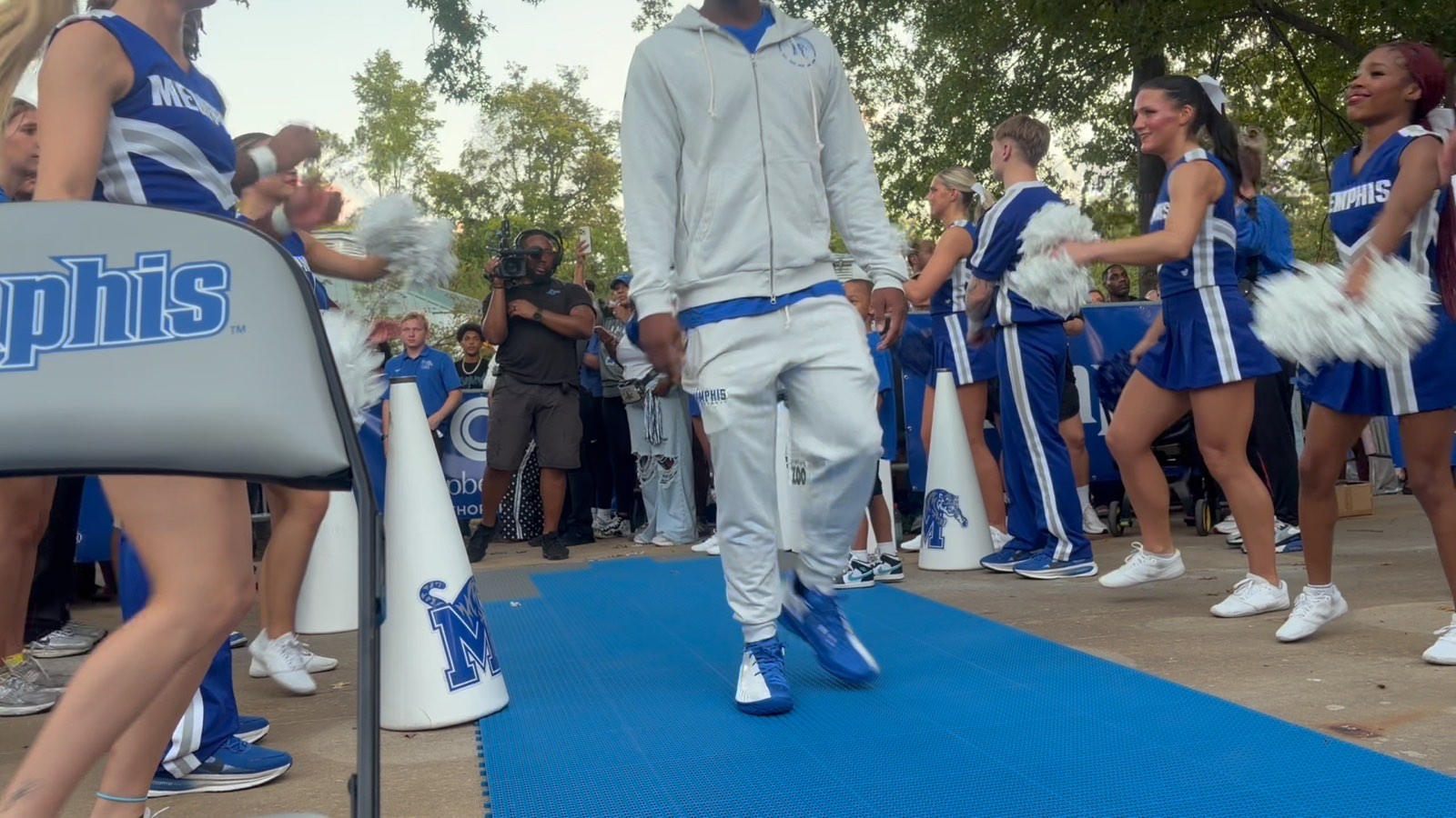 Memphis cheerleaders with pom-poms lining the edge of the outdoor court